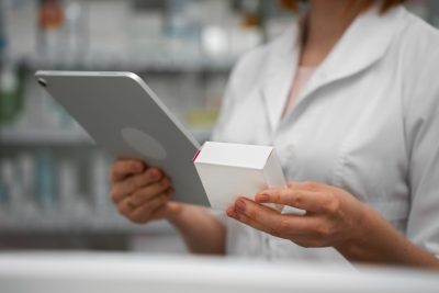pharmacist with tablet - ADV Pharmacy